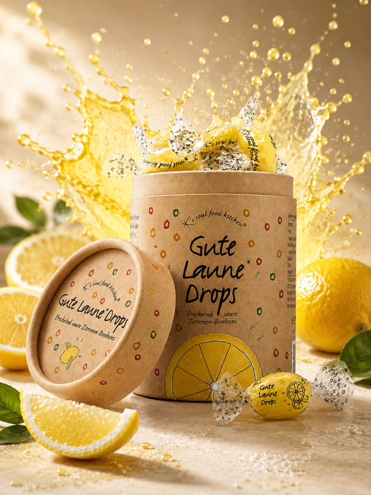 Gute Laune Drops Runddose 150g von K's Soul Food Kitchen vor buntem Hintergrund mit Zitronen