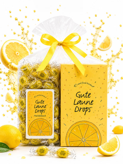 Bundle: Gute Laune Dispenser & Nachfüllpack von K's Soul Food Kitchen vor buntem Hintergrund mit Zitronen