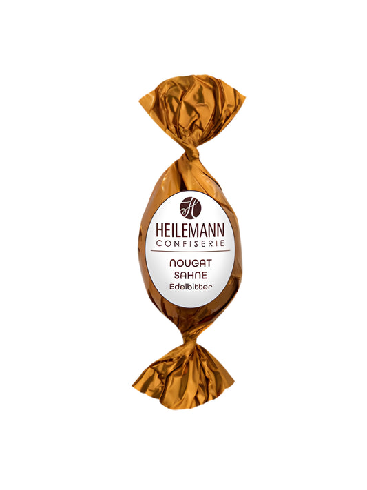 Heilemann Nougat-Sahne-Osterei: Edelbitterschokolade mit zartschmelzender Nougat-Sahne-Füllung, perfekt zum Verschenken oder Dekorieren, erhältlich in der Confiserie Dreyer.